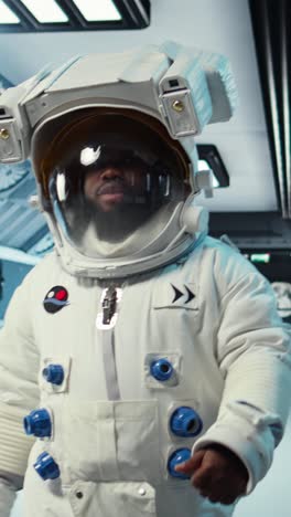 vertical video scientist wearing helmet walking in cutting edge spaceship, doing cosmic voyage