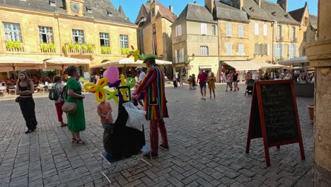 clown creates balloon animals for passersby