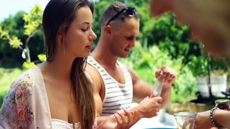 Group-of-friends-having-meal-at-outdoors-barbecue-party