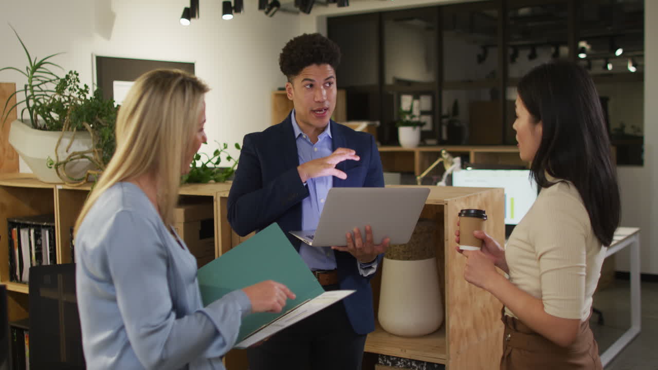 A diverse business team discusses a project in an office