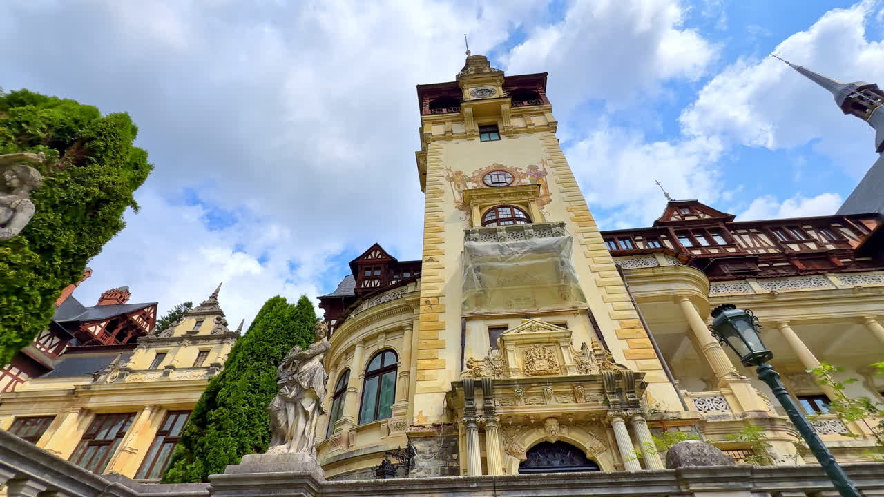 Sinaia, Romania, 17 July 2025: Peles Castle tower in Sinaia Romania. Gothic-Renaissance style tower of Peles Castle in Sinaia with cloudy sky above