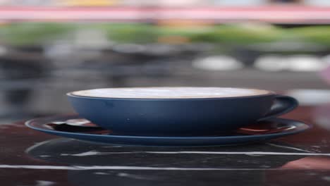 a cup of cappuccino on a marble table