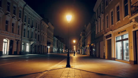 empty city street at night with glowing streetlights