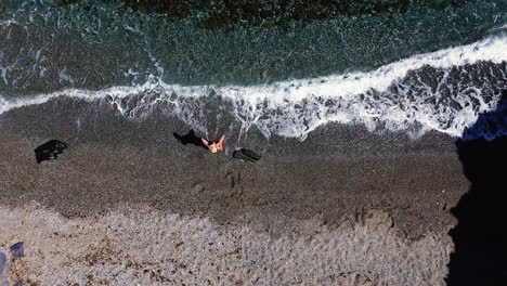 people at the beach aerial drone view playing beach tennis, sunbathing, enjoy holidays at the seashore