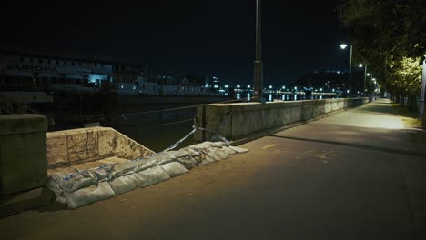 bolsas de arena de defensa contra inundaciones alinean una pasarela a la orilla del río a medida que las aguas de la inundación se elevan a lo largo del danubio