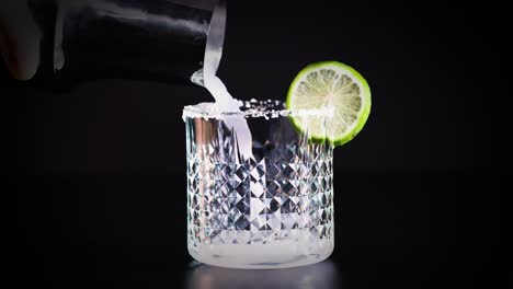 margarita cocktail being poured into a glass