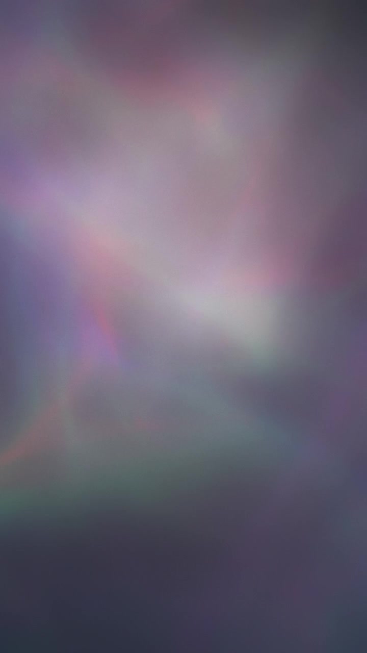 Colorful changing wavy lights flowing in an abstract pattern. Vertical.