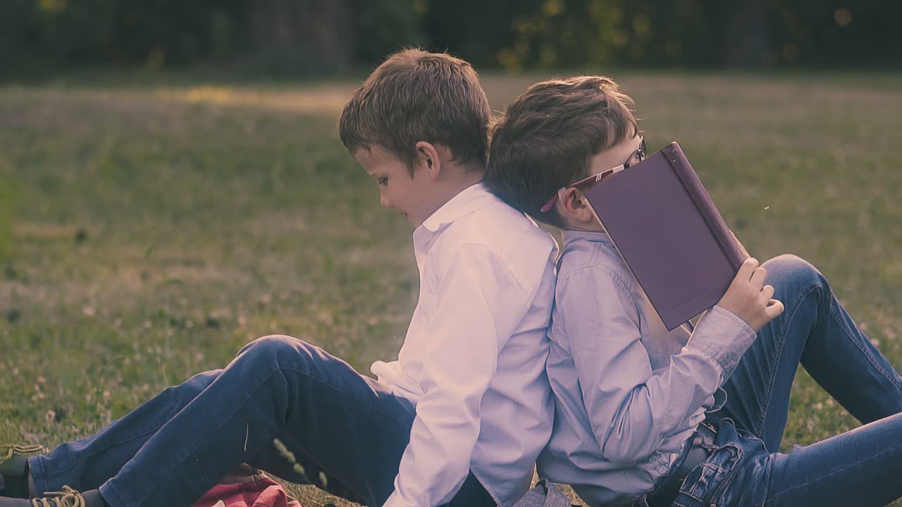 셔츠를 입은 학생이 책 뒤에 숨어서 물러납니다.