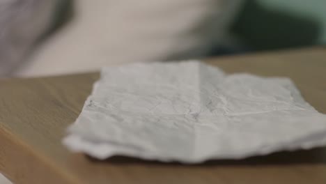 Close-up-of-paper-pickup-from-table-top