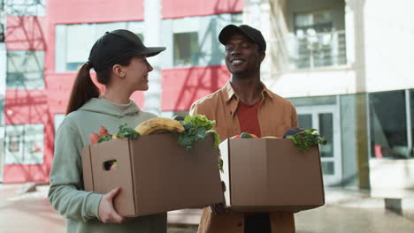 couriers holding boxes outdoors