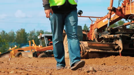 motor grader leveling ground on construction site. dirty heavy machinery working