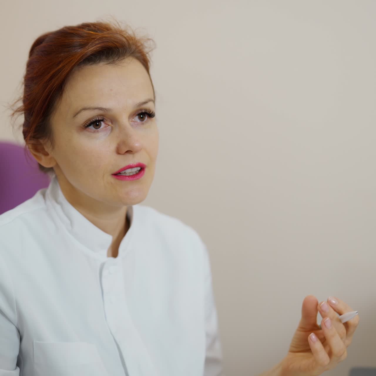 Doctor explaining the diagnosis. Female medical specialist in white coat sitting in chair and talking about the test results in clinic.
