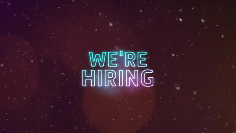 animation of we're hiring text over snow falling and spots