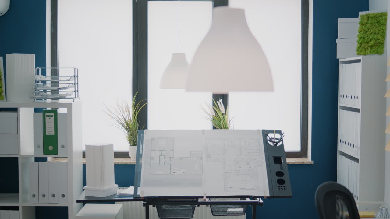 Nobody in office with blueprints plans to design building model for architecture project