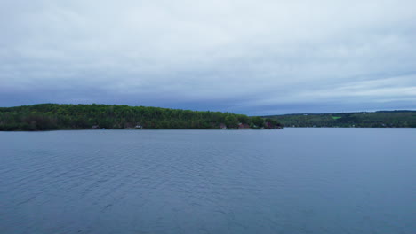 Drone-view-facing-two-people-kayaking-on-a-lake