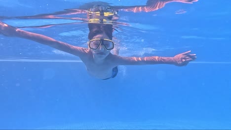enjoy a captivating snorkeling adventure as an individual immerses themselves in serene blue waters, discovering the wonders beneath the surface. the tranquility and beauty are mesmerizing