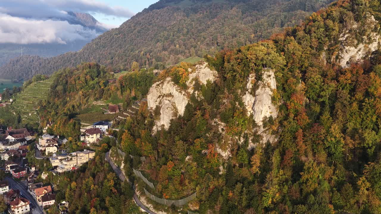 Colorful autumn forest and rocky cliffs overlooking Walensee near Walenstadt Switzerland