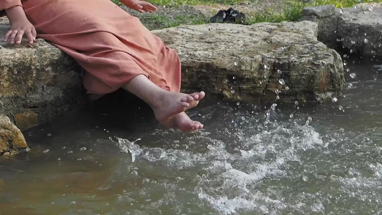 Woman's Feet Splashing in Shallow Water