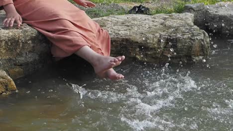 woman's feet splashing in shallow water