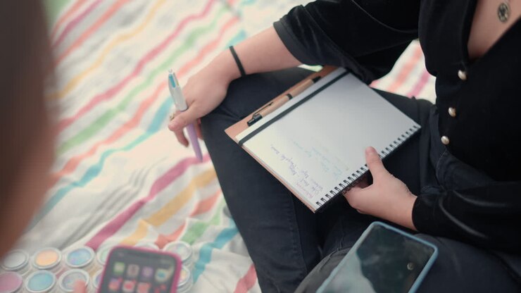 People having a meeting outdoors on a colorful blanket