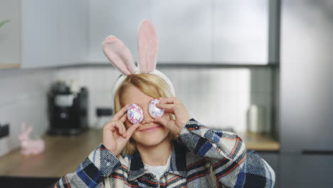 girl with easter bunny ears and eggs