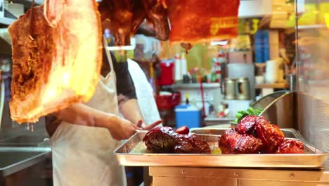 chef preparing crispy pork in a bustling kitchen