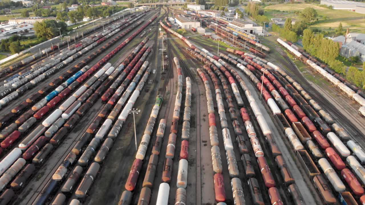 Aerial dolly shot Showing Large Train Depot With Many colorful cargo Trains