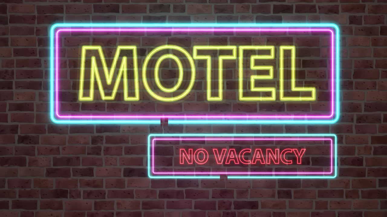 Enseigne de motel néon animée clignotant sur un mur de briques sombre avec des effets de lumière éclatants