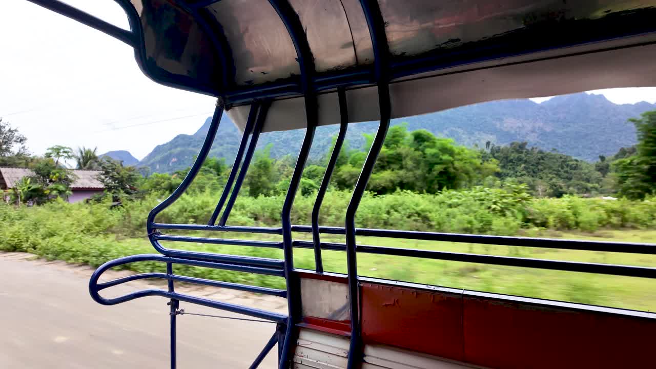 View from the back of a taxi in Vang Vieng Laos capturing the roadside scenery