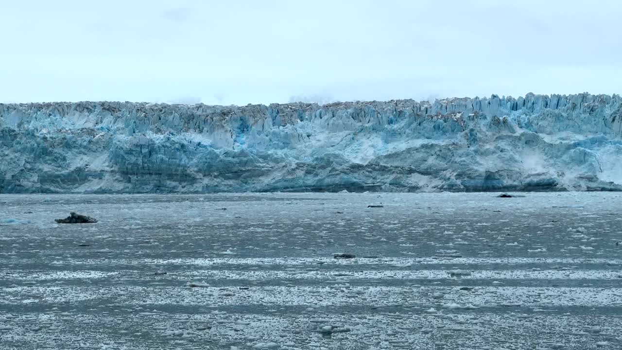 Explore the serene beauty of Hubbard Glacier in Glacier Bay, Alaska. The mesmerizing icy landscape reveals the majesty of nature, with icebergs floating in the calm waters.