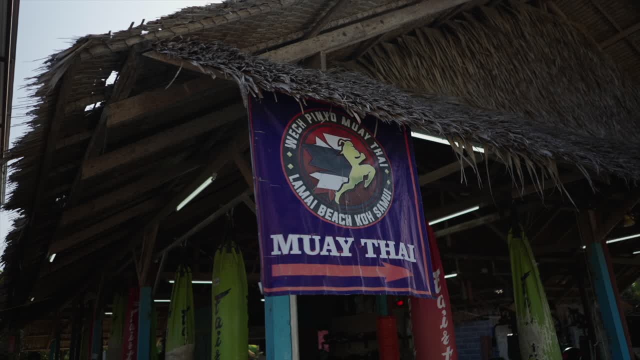 Muay Thai Training Camp with Thatched Roof and Punching Bags in Koh Samui