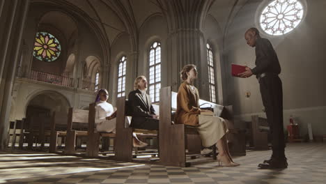 african clergyman talking to parishioners in church