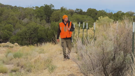 the hunter walks towards the right location to aim at the deer during the animal hunting season. fun hobby adventure in the wild.