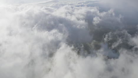 High-aerial-view-over-thick-white-clouds-moving-over-the-nature-of-Hawaii-on-a-sunny-day