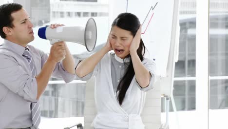 Angry-businessman-yelling-through-a-megaphone