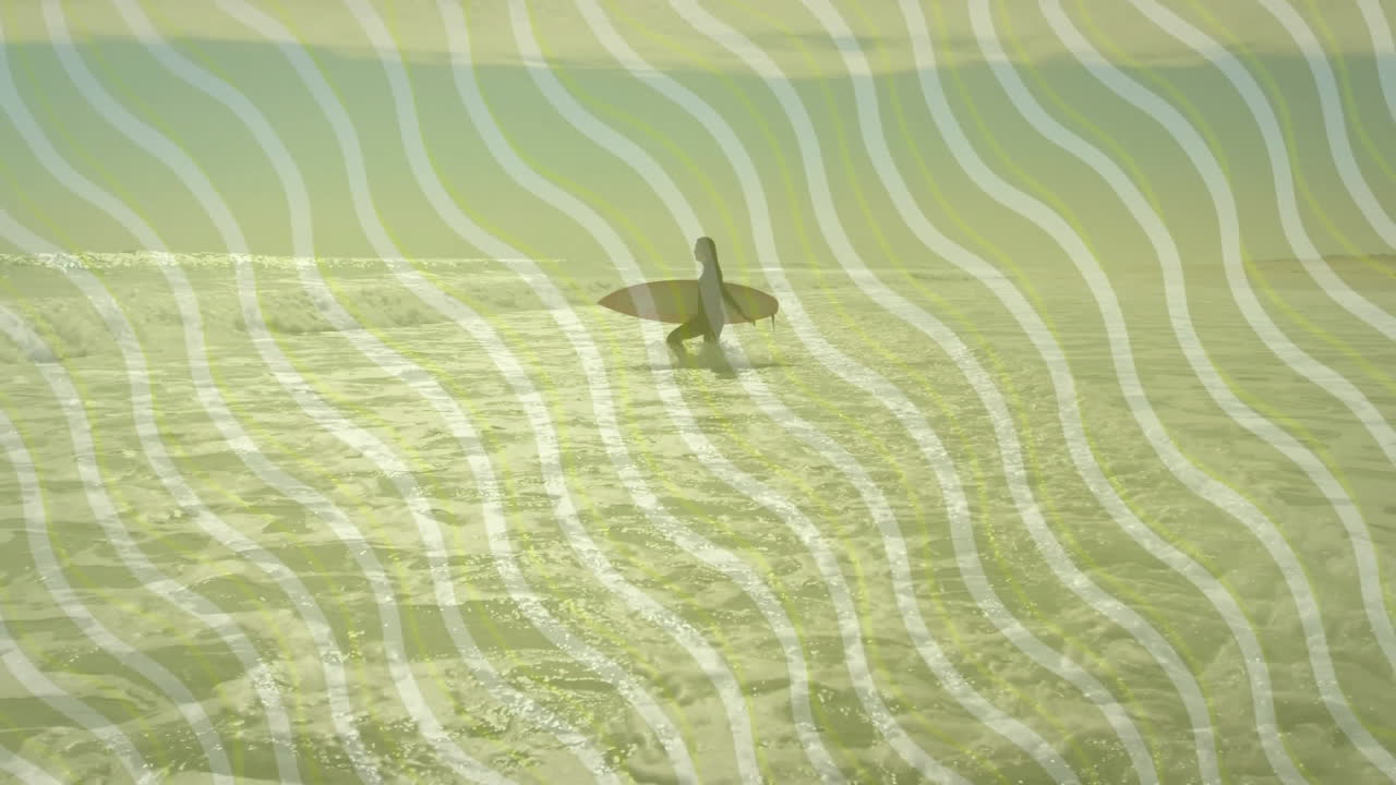 Surfer carrying surfboard walking into ocean at sunrise, health industry graphic showing wavy lines