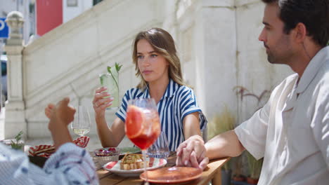 relaxed woman drinking cocktail street cafe closeup. lady holding boyfriend hand