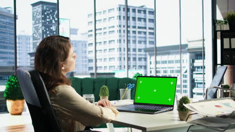 Woman-company-leader-looking-at-isolated-chroma-key-display