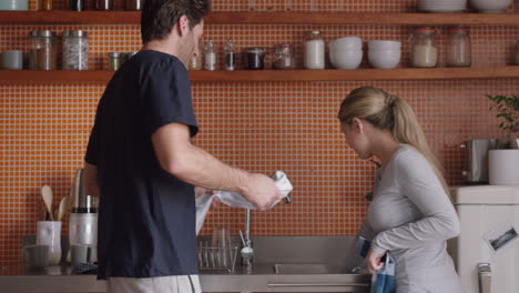 happy couple playing in kitchen washing dishes dancing having fun enjoying relaxing weekend together at home