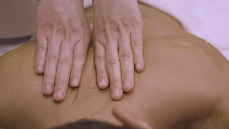 close up slow motion of deep tissue back massage, thumb pressure relaxing back massage , ease back and neck pain, thai massage spa