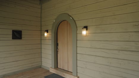 Approaching-a-beautiful-wooden-door-from-the-deck-of-a-cottage-at-the-Le-Belvédère-events-center-in-Wakefield,-Quebec