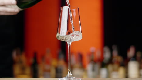 pouring champagne into wine glass