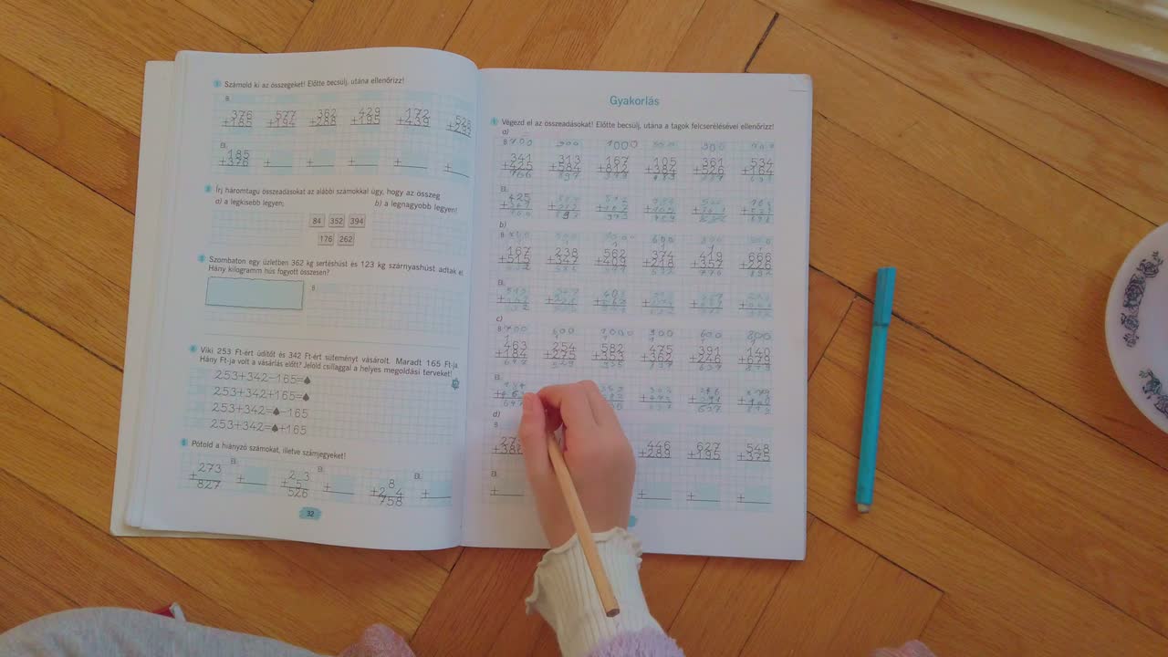 A child engaged in independent math study at home. This high-quality footage represents the modern shift toward personalized learning, distance education, and the comfort of a home-school environment