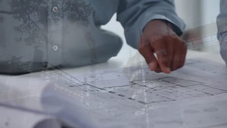 architects discussing over blueprints with construction site