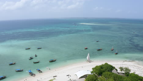 boats anchoring in shallow tropical coastal ocean waters, drone shot