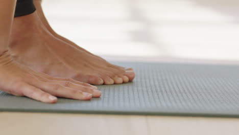 close up hands yoga woman practicing poses enjoying fitness lifestyle exercising in studio stretching body training on exercise mat