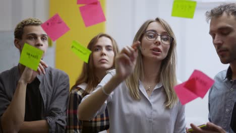 diverse group of finance office worker having corporate training and using glass wall