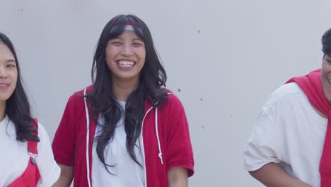 young indonesian men and women cheering and shouting in celebration of indonesia independence day