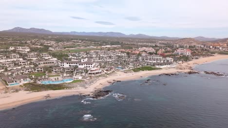 the luxurious four seasons resort in cabo san lucas, mexico. pull back aerial shot.