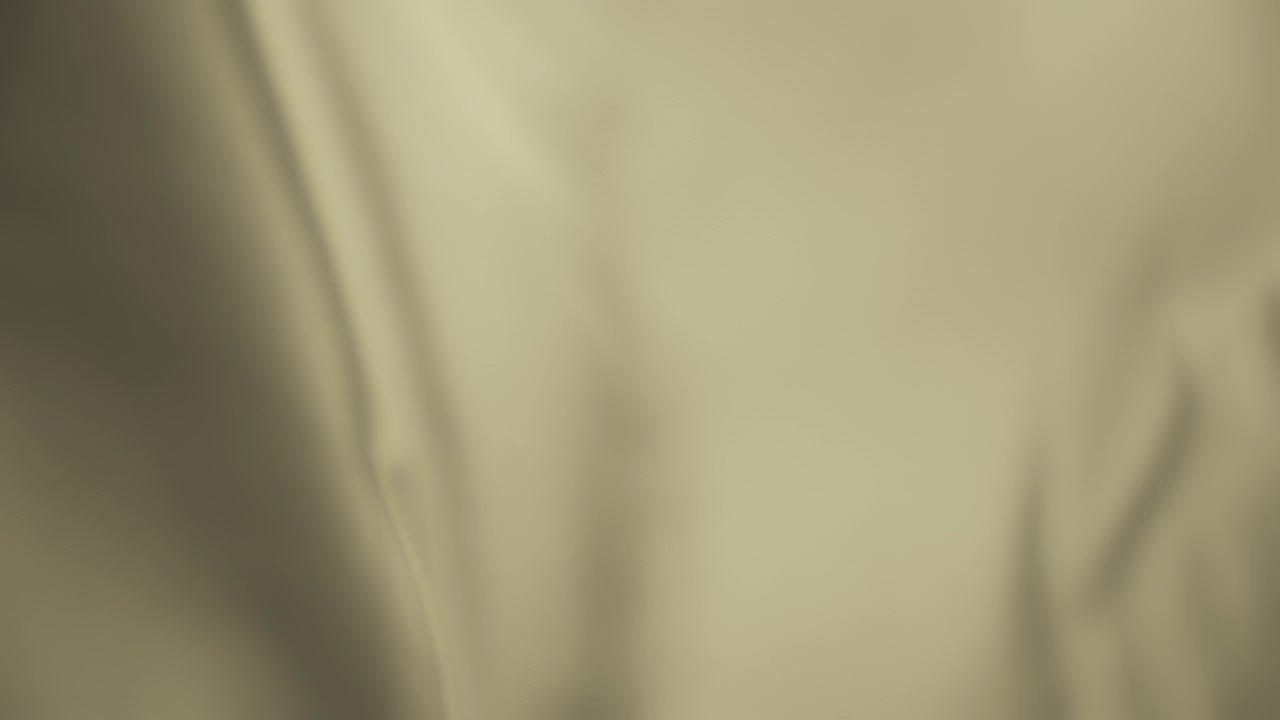Light yellow chiffon textile waving in the wind